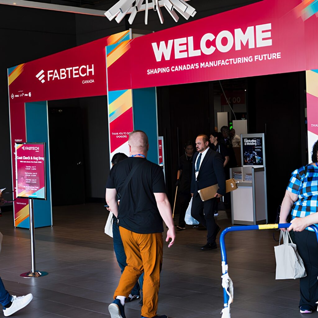 Entrance banner for FabTech event with people entering the event.